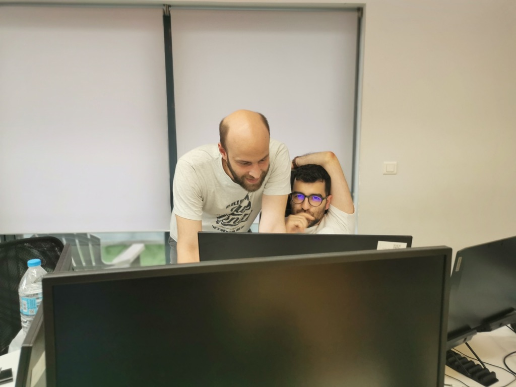 Two engineers working at monitors